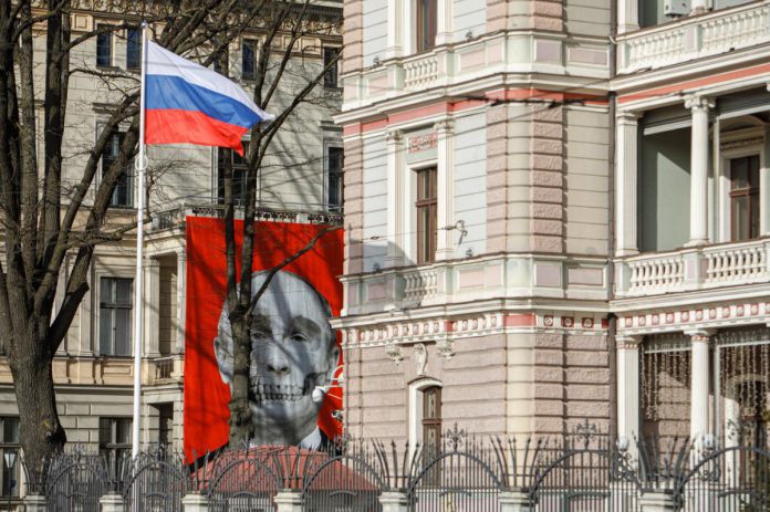 Российское посольство в Риге. Напротив него плакат, созданный Андрисом Бреже и Каспаром Ванагом. Фото: KRIŠS SALMANIS / salmanis.com