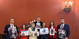 Депутаты Сейма Латвии и правозащитница Айя Стаценко из Libereco с портретами белорусских политзаключённых. Рига, Латвия, январь 2025 года. Фото: Дагния Шика